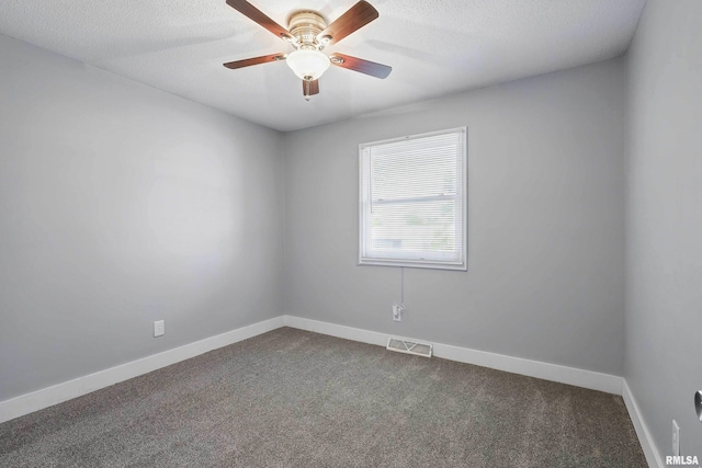 1413 N Pioneer St, Davenport, IA 52804 - empty room featuring dark colored carpet, baseboards, ceiling fan, and a textured ceiling
