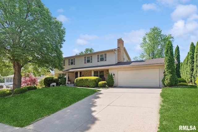 741 12th Ave N, Clinton, IA 52732 - traditional home with a garage, concrete driveway, a front lawn, and a chimney