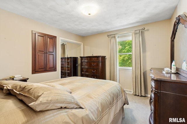 741 12th Ave N, Clinton, IA 52732 - bedroom featuring light carpet, a closet, and baseboards