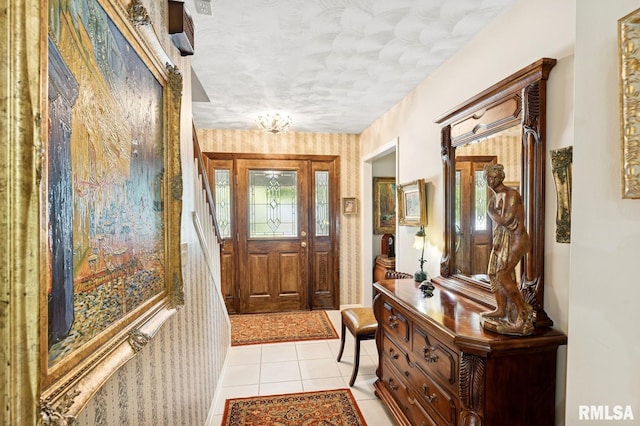 741 12th Ave N, Clinton, IA 52732 - entrance foyer featuring light tile patterned floors, a textured ceiling, and wallpapered walls