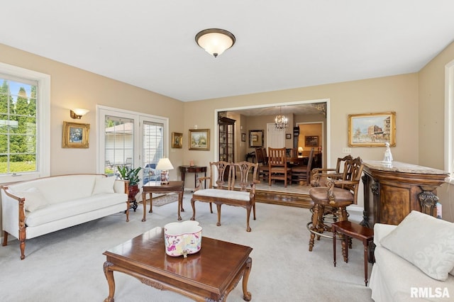 741 12th Ave N, Clinton, IA 52732 - living room with light carpet and a chandelier
