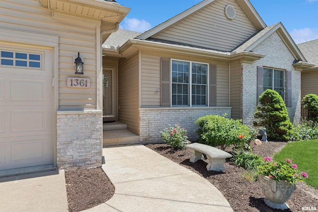 1361 Pinnacle Pines Ct, Bettendorf, IA 52722 - doorway to property featuring brick siding and a shingled roof
