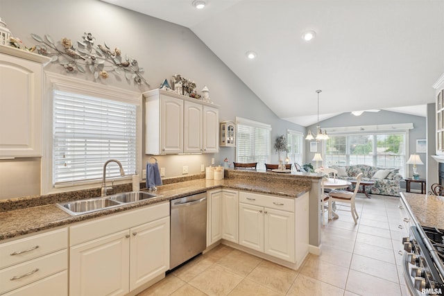 1361 Pinnacle Pines Ct, Bettendorf, IA 52722 - kitchen featuring stainless steel appliances, a sink, lofted ceiling, a peninsula, and light tile patterned flooring