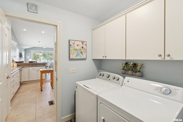 1361 Pinnacle Pines Ct, Bettendorf, IA 52722 - washroom with washer and clothes dryer, light tile patterned flooring, cabinet space, baseboards, and recessed lighting