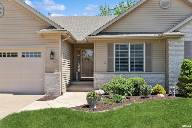 1361 Pinnacle Pines Ct, Bettendorf, IA 52722 - view of exterior entry with brick siding, an attached garage, a shingled roof, and driveway