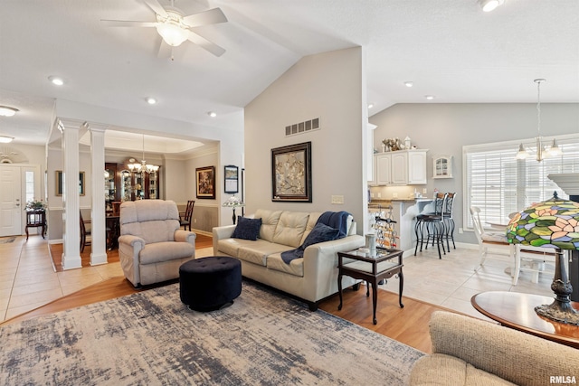 1361 Pinnacle Pines Ct, Bettendorf, IA 52722 - living area with a chandelier, vaulted ceiling, ceiling fan, decorative columns, and light wood-style flooring
