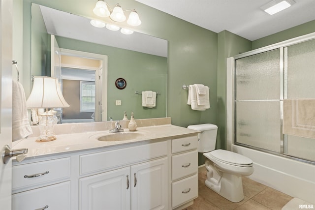 1361 Pinnacle Pines Ct, Bettendorf, IA 52722 - ensuite bathroom with tile patterned flooring, vanity, toilet, and combined bath / shower with glass door