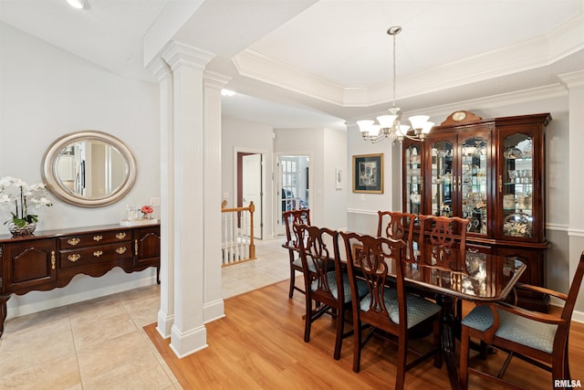 1361 Pinnacle Pines Ct, Bettendorf, IA 52722 - dining room with ornate columns, a chandelier, ornamental molding, a tray ceiling, and light wood finished floors