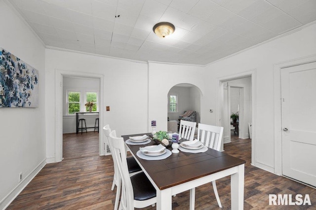 1603 Judson St, Davenport, IA 52803 - dining space with arched walkways, ornamental molding, and dark wood-style floors