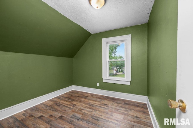 1603 Judson St, Davenport, IA 52803 - additional living space featuring baseboards, dark wood finished floors, lofted ceiling, and a textured ceiling