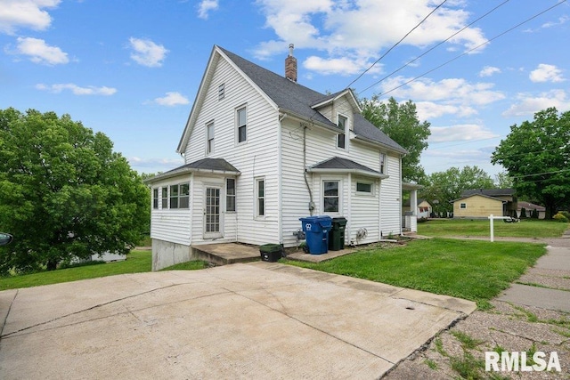 1603 Judson St, Davenport, IA 52803 - view of side of home with a lawn, a chimney, a patio, and roof with shingles