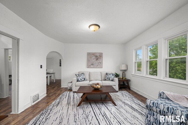 1603 Judson St, Davenport, IA 52803 - living area with arched walkways, wood finished floors, a textured ceiling, and baseboards