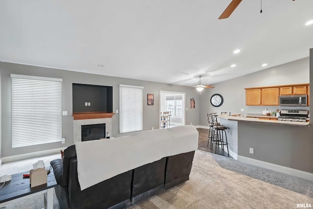 6732 Brookview Ln, Davenport, IA 52806 - living area with a ceiling fan, baseboards, a tile fireplace, recessed lighting, and carpet flooring