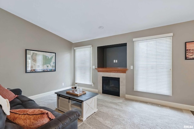 6732 Brookview Ln, Davenport, IA 52806 - living area featuring light carpet, baseboards, a fireplace, and vaulted ceiling