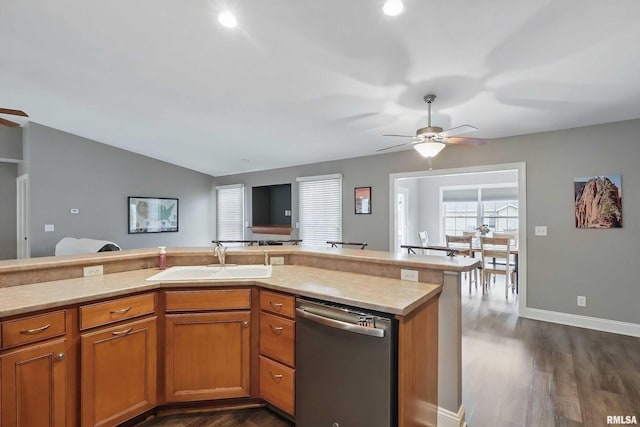 6732 Brookview Ln, Davenport, IA 52806 - kitchen with stainless steel dishwasher, a sink, a ceiling fan, light countertops, and dark wood-style flooring