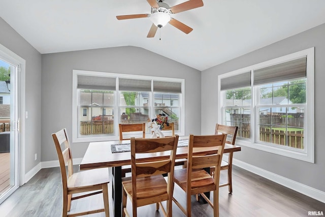 6732 Brookview Ln, Davenport, IA 52806 - dining space featuring light wood-type flooring, lofted ceiling, baseboards, and a ceiling fan