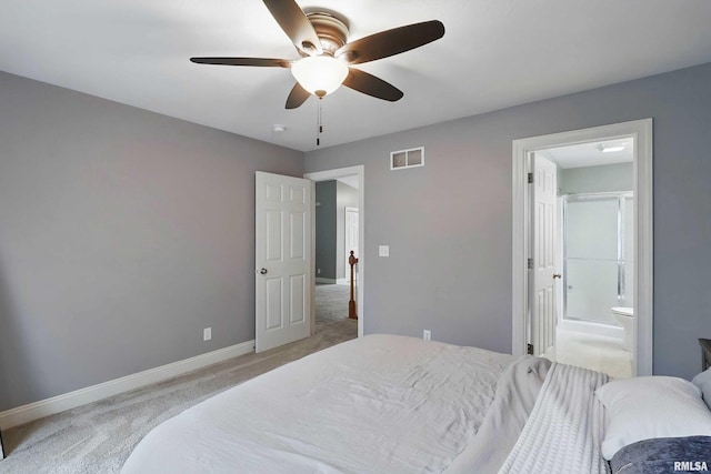 6732 Brookview Ln, Davenport, IA 52806 - bedroom with light colored carpet, baseboards, ensuite bathroom, and ceiling fan