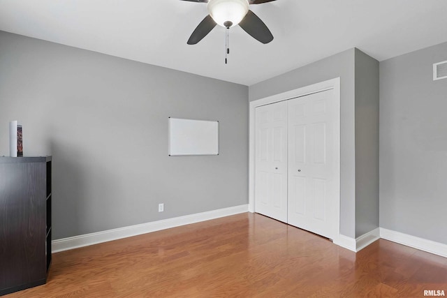 6732 Brookview Ln, Davenport, IA 52806 - unfurnished bedroom with wood finished floors, a closet, and baseboards