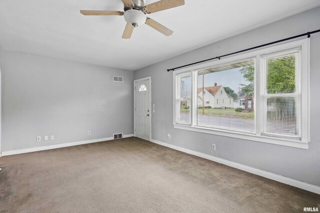 3129 Harrison St, Davenport, IA 52803 - unfurnished room featuring carpet, baseboards, and a ceiling fan