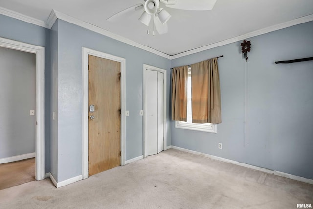 3129 Harrison St, Davenport, IA 52803 - unfurnished bedroom featuring carpet flooring, crown molding, baseboards, a ceiling fan, and a closet