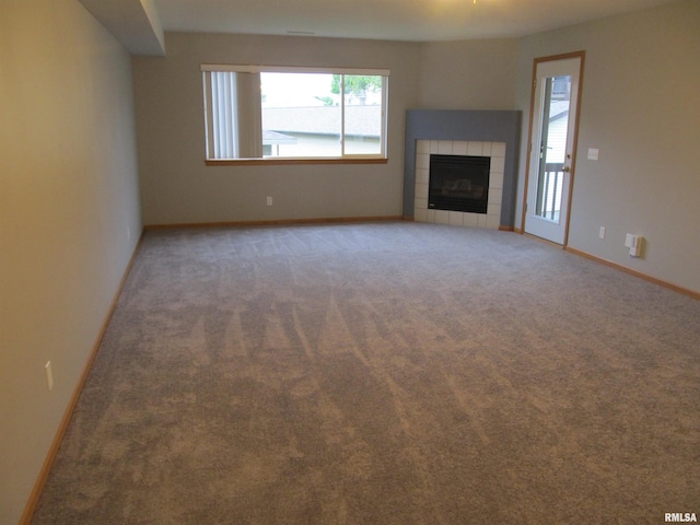 4186 Fairview Dr Unit 5, Bettendorf, IA 52722 - unfurnished living room with carpet floors, a tiled fireplace, and baseboards