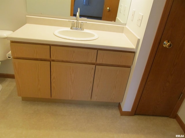 4186 Fairview Dr Unit 5, Bettendorf, IA 52722 - bathroom featuring vanity, baseboards, and toilet