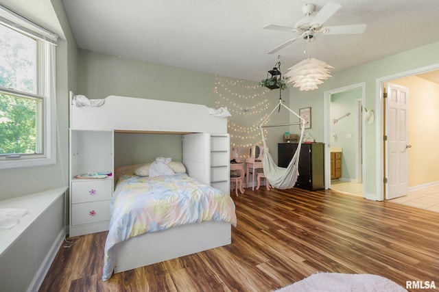 1816 Calico Rd, Marion, IL 62959 - bedroom with wood finished floors, multiple windows, ensuite bath, and a ceiling fan