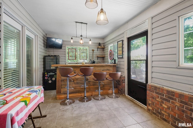 1816 Calico Rd, Marion, IL 62959 - indoor dry bar with tile patterned floors, wooden walls, and hanging light fixtures