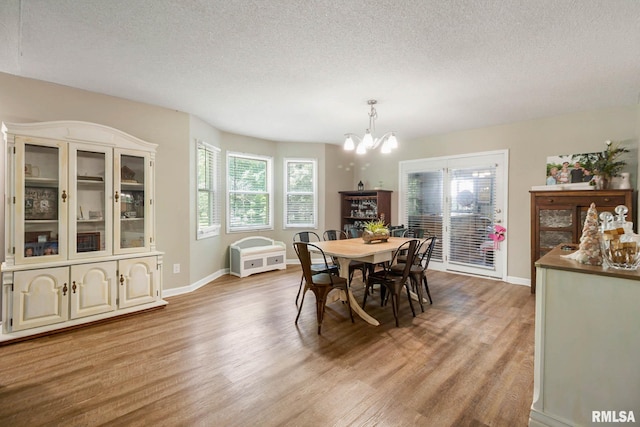 1816 Calico Rd, Marion, IL 62959 - dining space featuring a chandelier, wood finished floors, healthy amount of natural light, and a textured ceiling