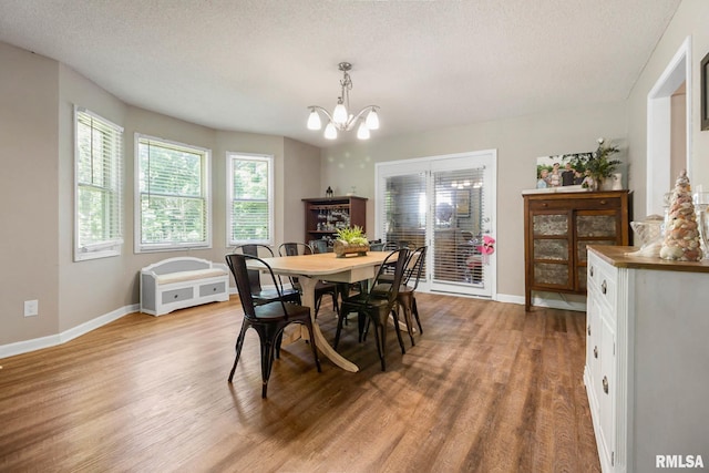 1816 Calico Rd, Marion, IL 62959 - dining space featuring light wood-style floors, a chandelier, plenty of natural light, and a textured ceiling