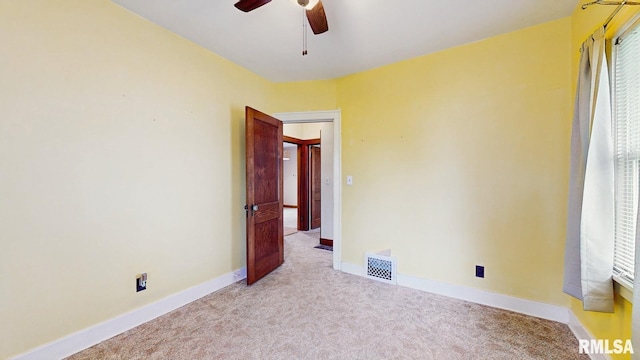 506 18th Ave, Moline, IL 61265 - spare room featuring light carpet, ceiling fan, baseboards, and plenty of natural light