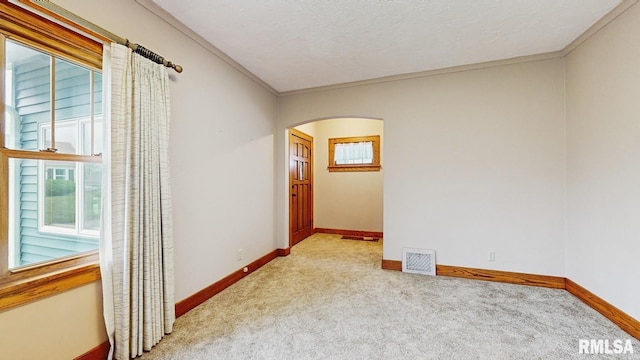 506 18th Ave, Moline, IL 61265 - carpeted empty room with arched walkways, baseboards, and ornamental molding