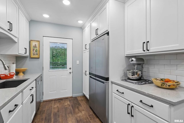 1104 Kimberly Rd Unit 1006, Bettendorf, IA 52722 - kitchen with freestanding refrigerator, a sink, dark wood finished floors, recessed lighting, and white cabinetry