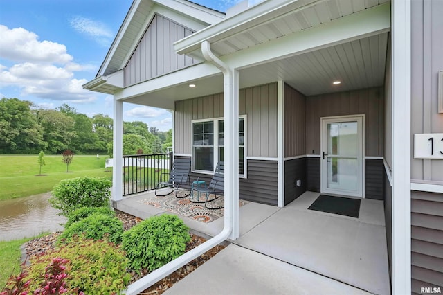 1327 Heights Ct, Bettendorf, IA 52803 - entrance to property with a porch, a water view, and view of scattered trees