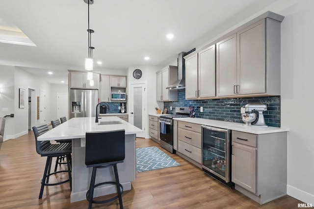 1327 Heights Ct, Bettendorf, IA 52803 - kitchen with appliances with stainless steel finishes, beverage cooler, a sink, wall chimney exhaust hood, and backsplash
