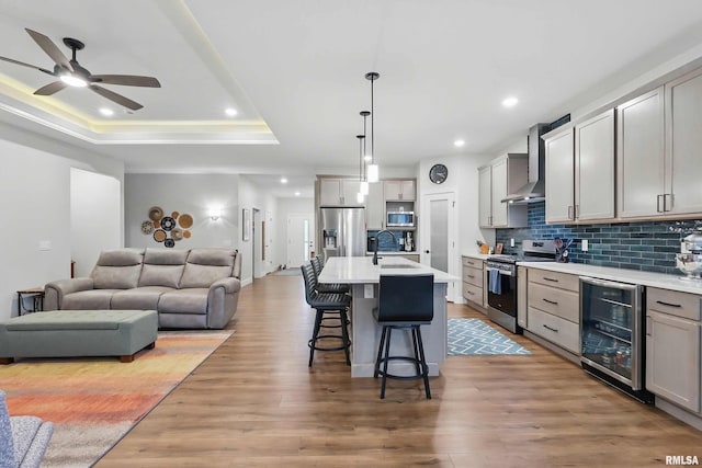 1327 Heights Ct, Bettendorf, IA 52803 - kitchen with wine cooler, appliances with stainless steel finishes, wall chimney exhaust hood, open floor plan, and a sink