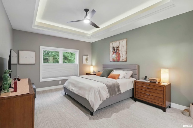 1327 Heights Ct, Bettendorf, IA 52803 - bedroom featuring a tray ceiling, baseboards, light carpet, and a ceiling fan