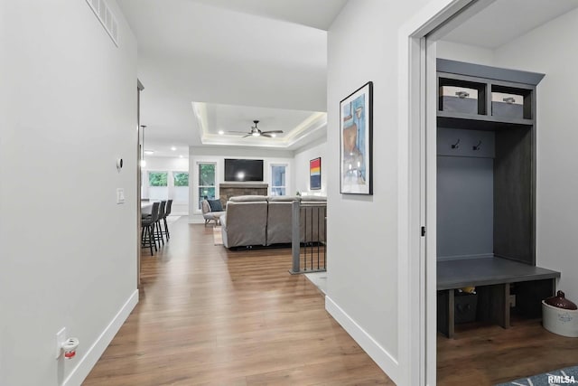 1327 Heights Ct, Bettendorf, IA 52803 - corridor with light wood finished floors, baseboards, and a raised ceiling