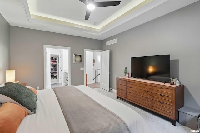 1327 Heights Ct, Bettendorf, IA 52803 - bedroom featuring light colored carpet, a tray ceiling, baseboards, and a spacious closet