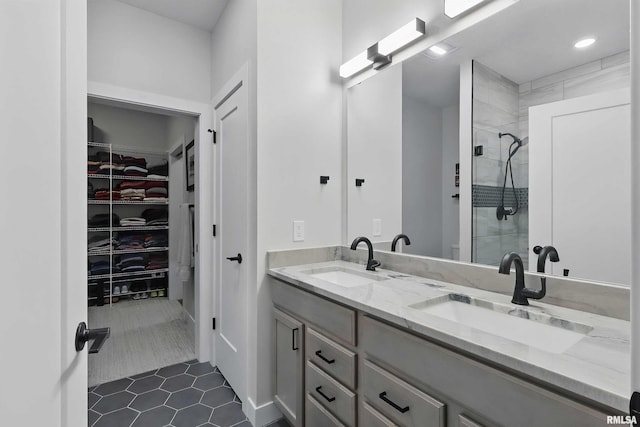 1327 Heights Ct, Bettendorf, IA 52803 - bathroom with double vanity, a walk in closet, a stall shower, tile patterned floors, and recessed lighting