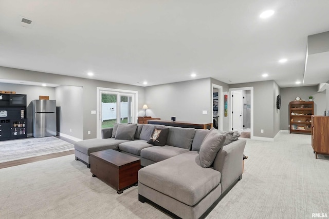 1327 Heights Ct, Bettendorf, IA 52803 - living room with recessed lighting, baseboards, and light carpet