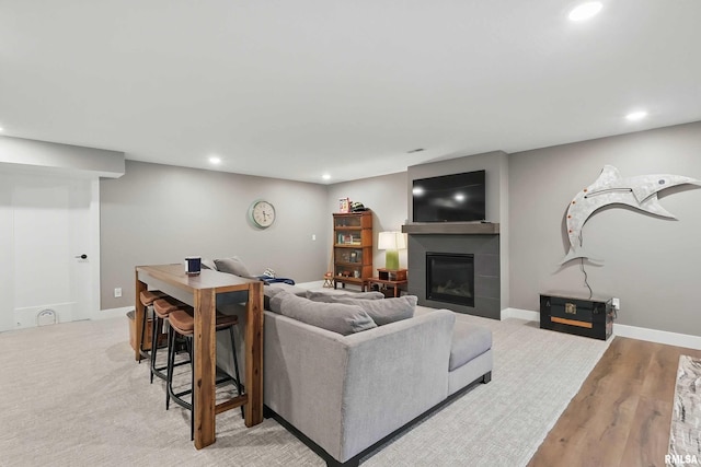 1327 Heights Ct, Bettendorf, IA 52803 - living room featuring recessed lighting, a tile fireplace, wood finished floors, and baseboards