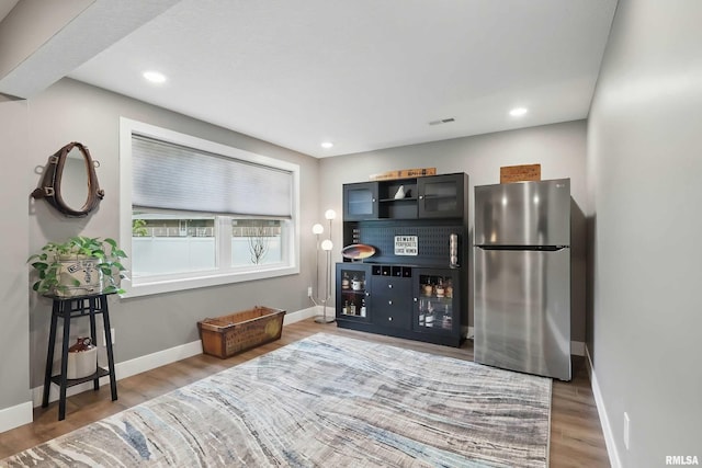 1327 Heights Ct, Bettendorf, IA 52803 - living area featuring baseboards, wood finished floors, and recessed lighting