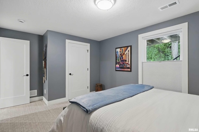 1327 Heights Ct, Bettendorf, IA 52803 - carpeted bedroom featuring baseboards, a closet, and a textured ceiling