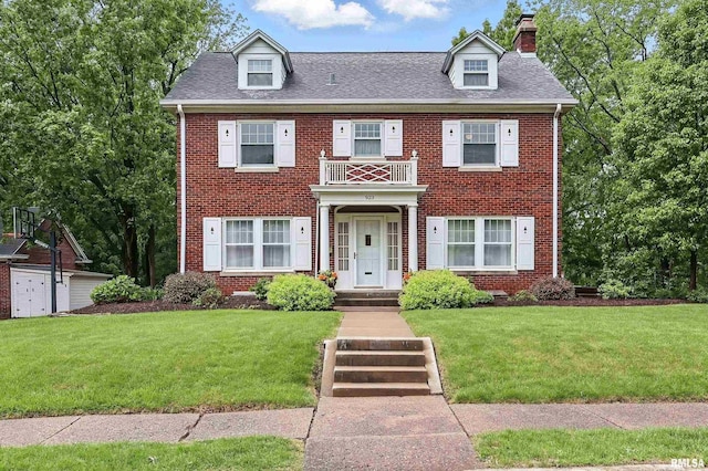923 22nd St, Moline, IL 61265 - georgian-style home with brick siding and a front yard