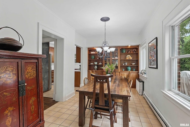 923 22nd St, Moline, IL 61265 - dining space with baseboard heating, a chandelier, light tile patterned floors, and crown molding