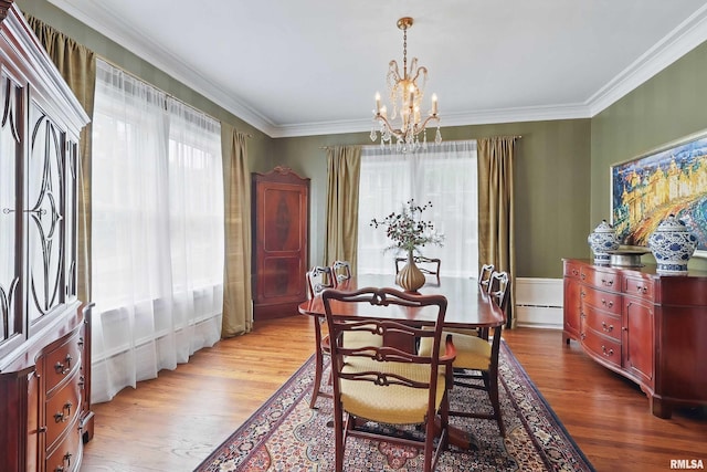 923 22nd St, Moline, IL 61265 - dining space with a chandelier, wood finished floors, ornamental molding, and a baseboard heating unit