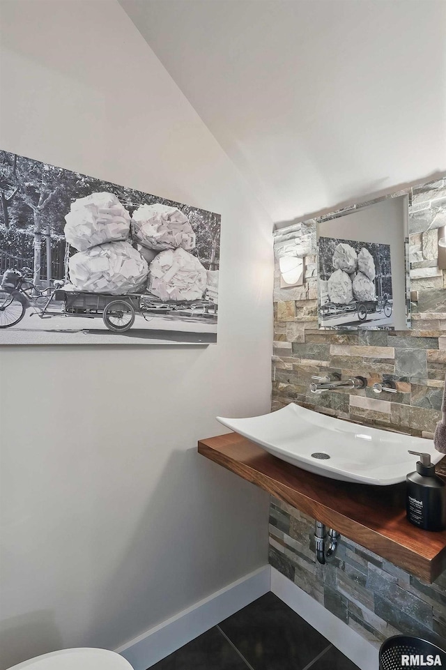 923 22nd St, Moline, IL 61265 - half bathroom with lofted ceiling, tile patterned floors, and toilet