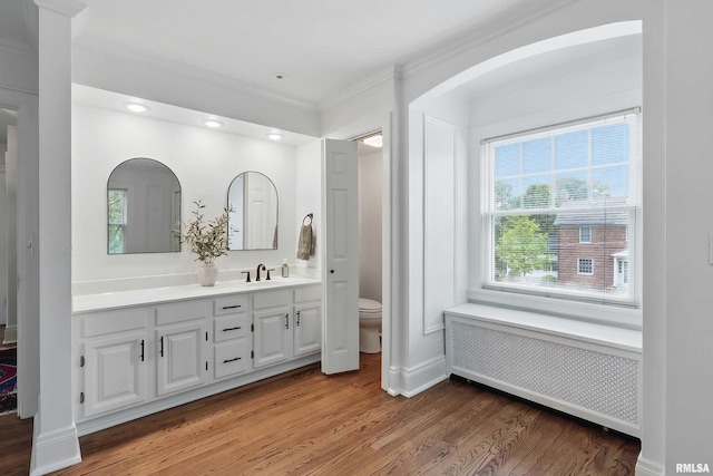 923 22nd St, Moline, IL 61265 - full bath featuring radiator, wood finished floors, vanity, ornamental molding, and toilet