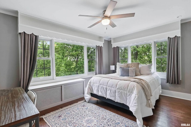 923 22nd St, Moline, IL 61265 - bedroom with radiator heating unit, wood finished floors, baseboards, and ceiling fan